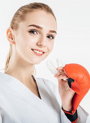 girl holding mouthguard