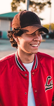 teen boy in hat and red jacket